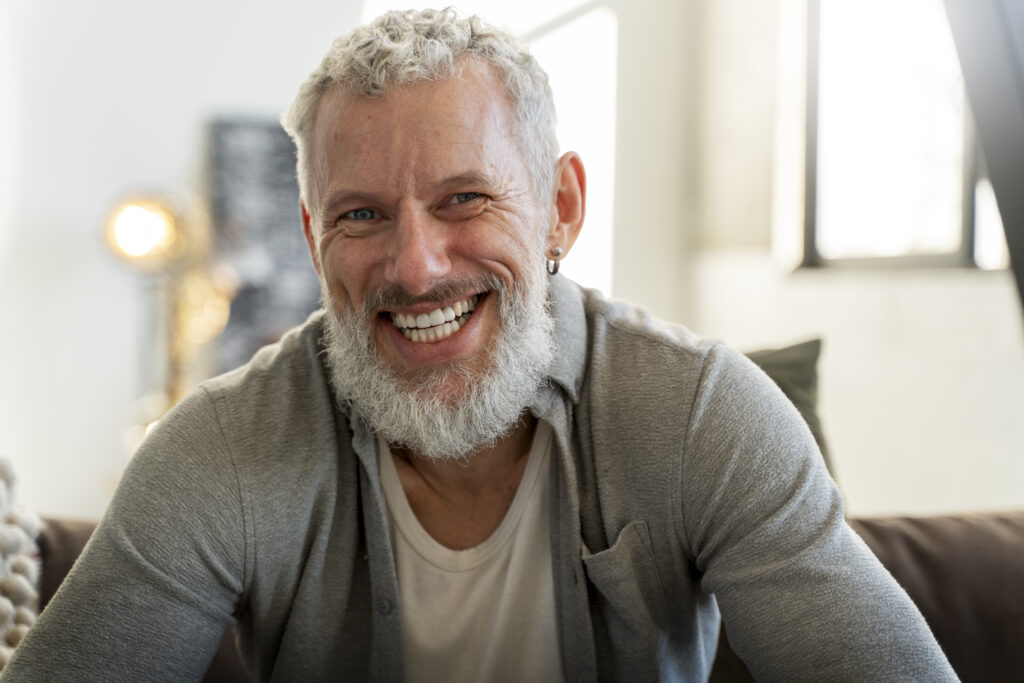 front-view-smiley-man-relaxing-home